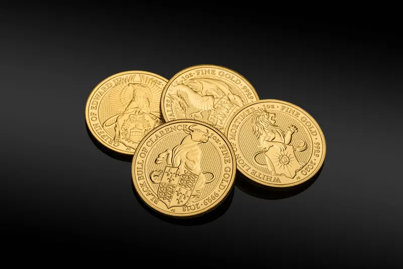 Close-up of gold coins featuring heraldic designs against a black backdrop. Perfect for finance and investment themes