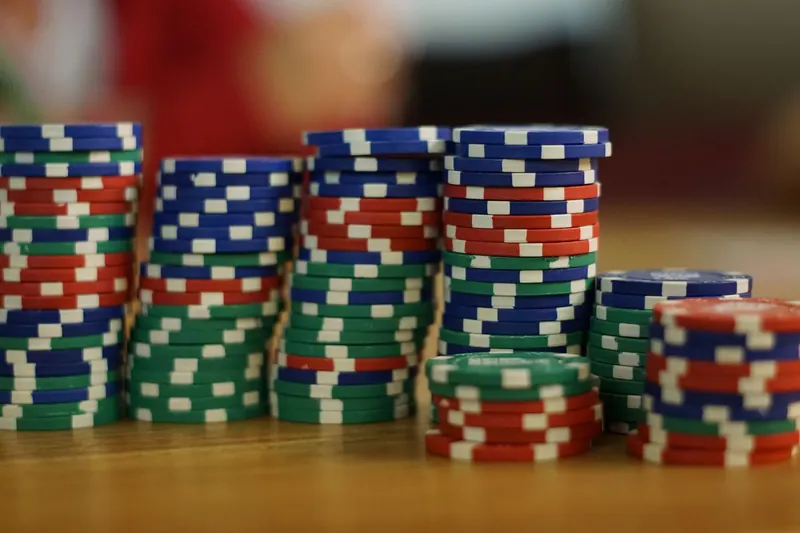 Colorful poker chips stacked on a wooden table