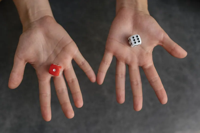 Two dice resting in open hands
