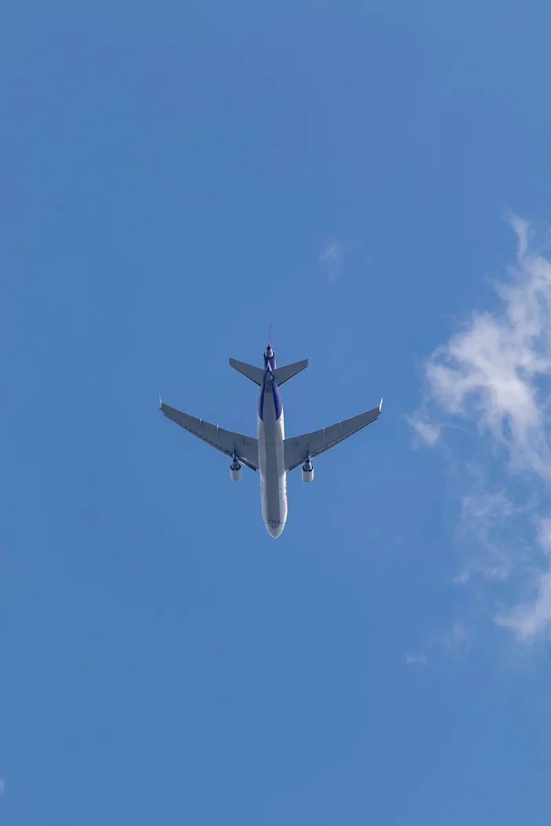 Commercial airplane climbing through a clear sky