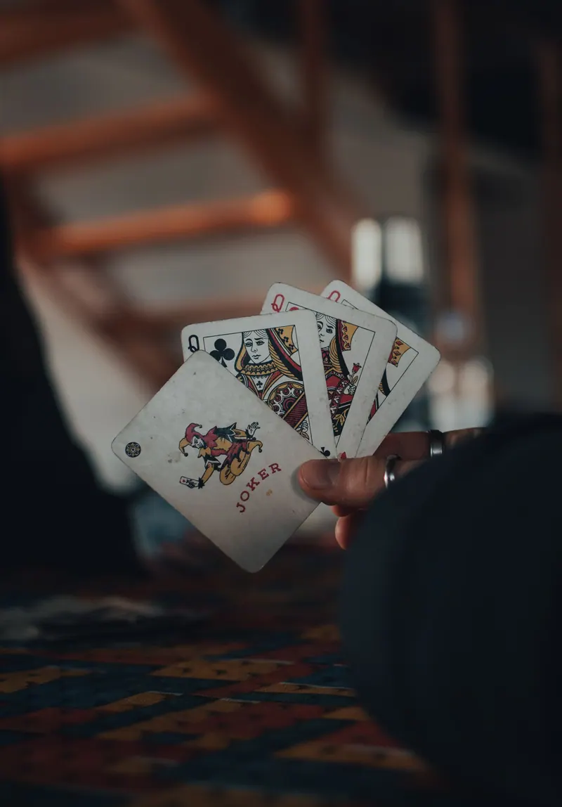 A hand holding a fanned set of playing cards