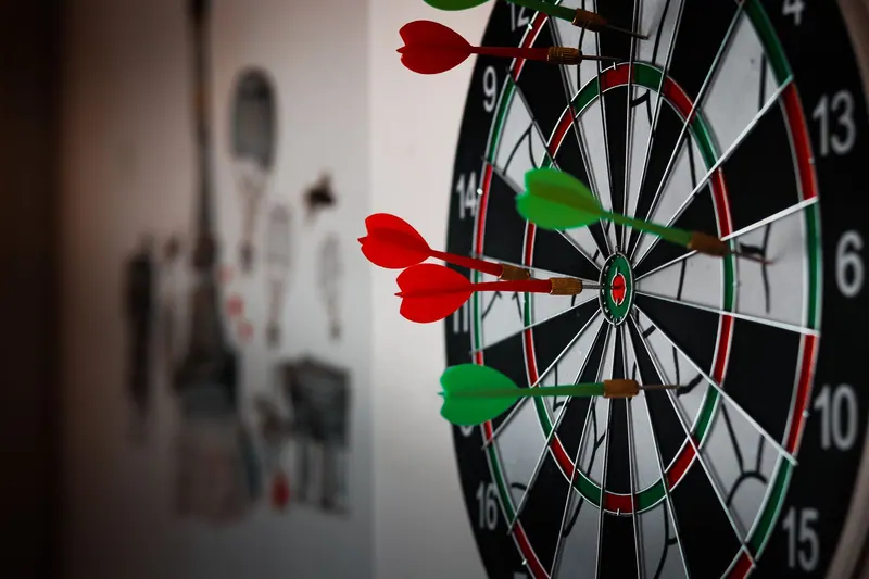 Darts clustered on the target center of a dartboard