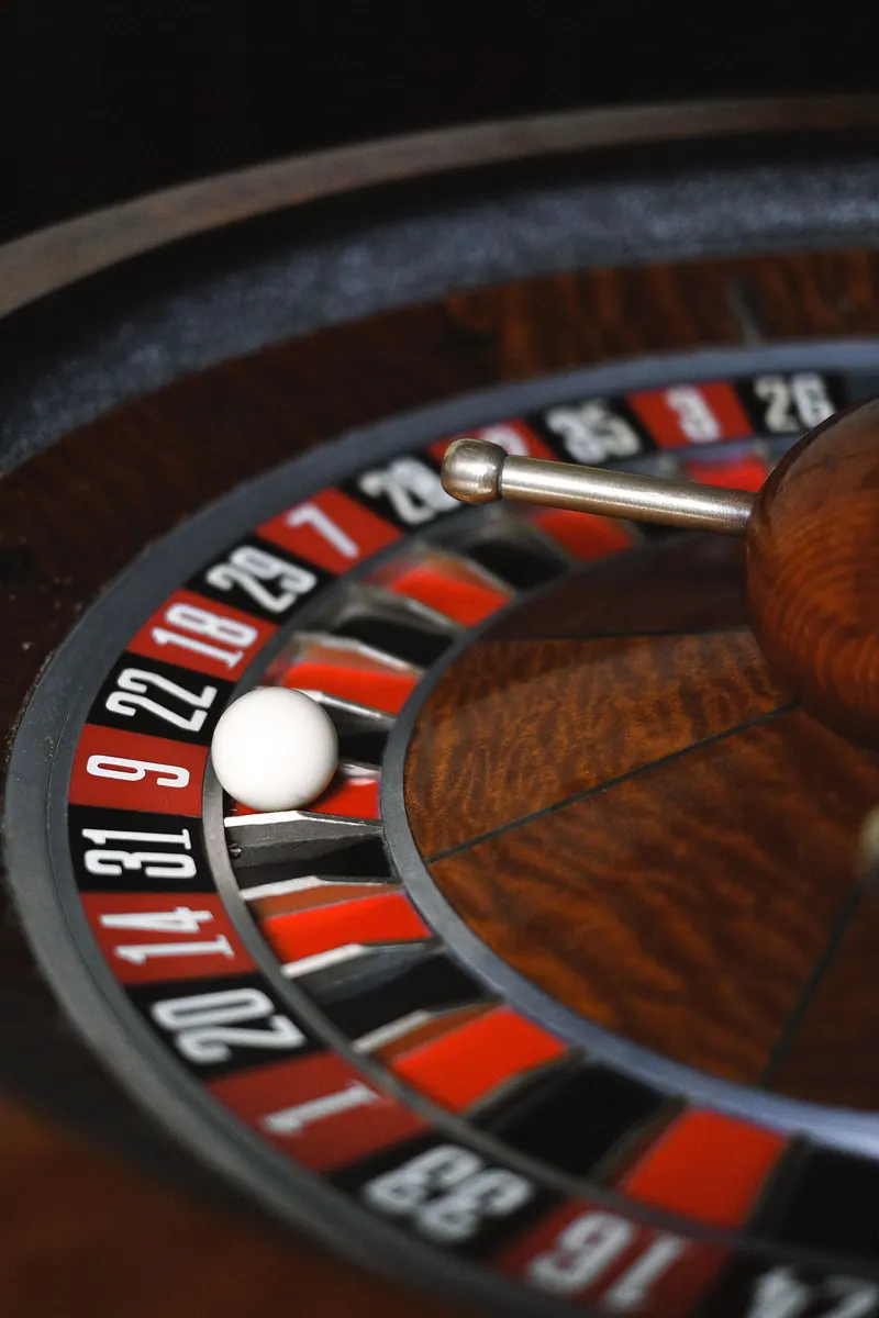 A spinning roulette wheel with the white ball in motion