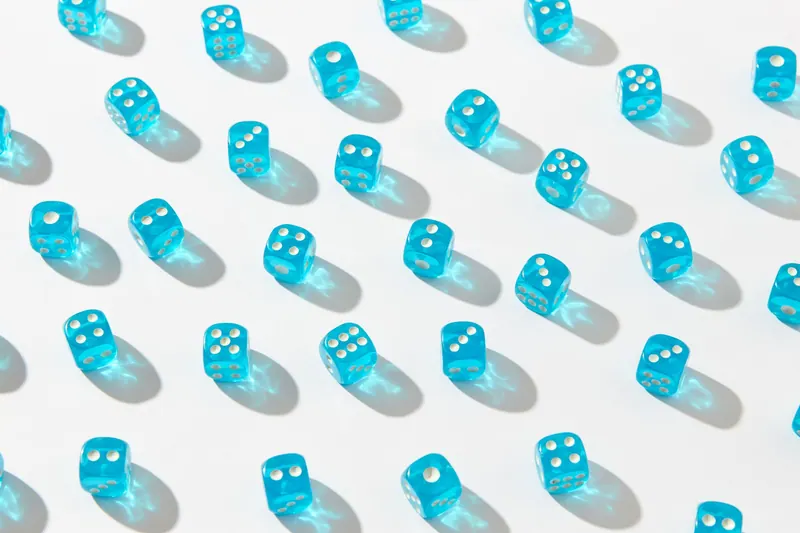 A scattered group of translucent blue dice