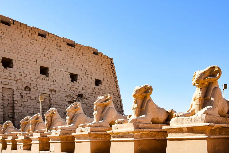 Row of ancient sphinx statues at the historic Karnak Temple Complex in Luxor, Egypt