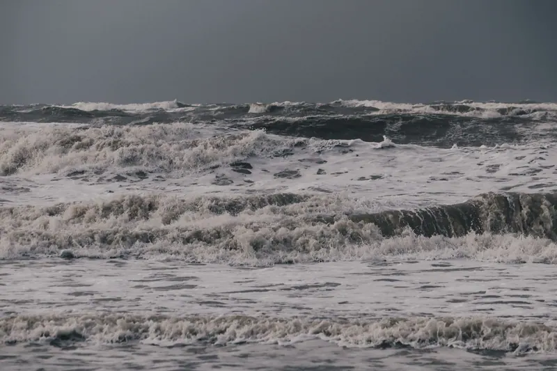 Powerful ocean waves under a stormy sky