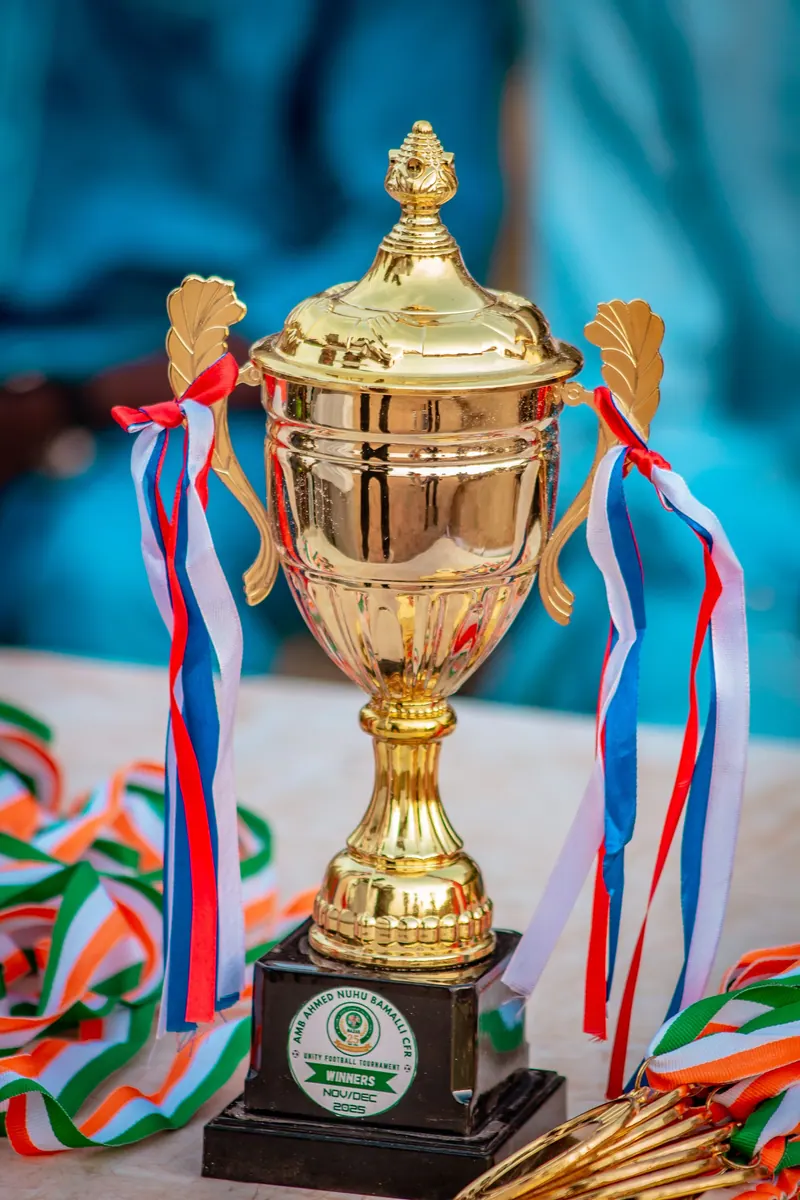 Golden trophy with red, white and blue ribbons