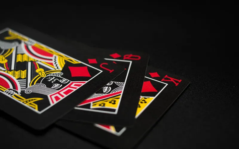 Close-up of playing cards showing king, queen, jack and ace of diamonds
