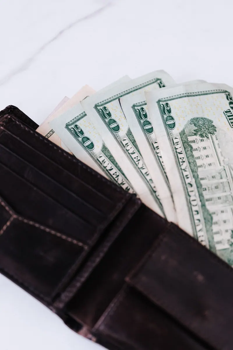 Leather wallet with US dollar bills